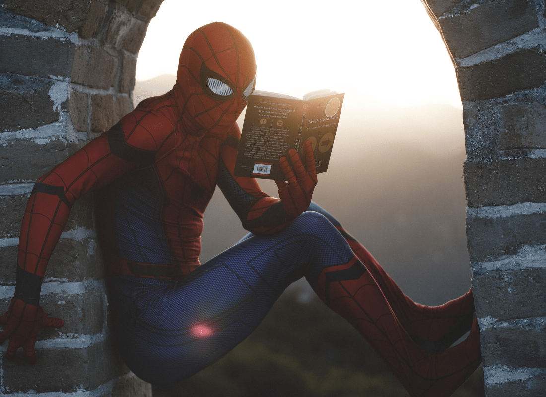 Confident Spider Man reading a book