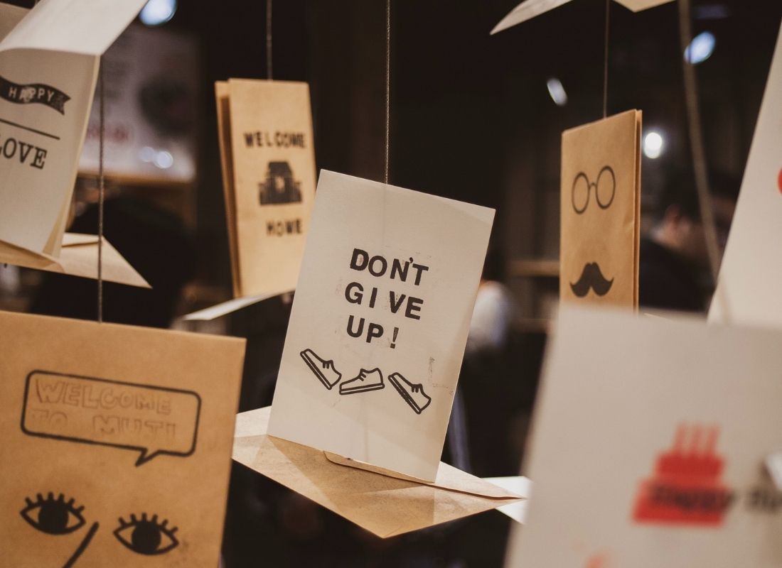 Cards hanging from ceiling with motivational team quotes