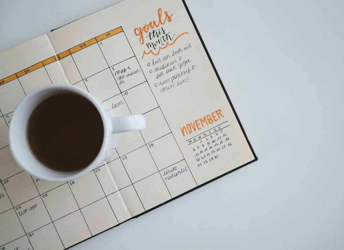 Goal planner with a mug of coffee sitting on it