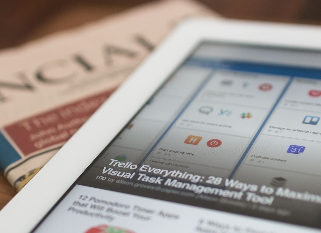 Tablet with article on marketing tips next to newspaper