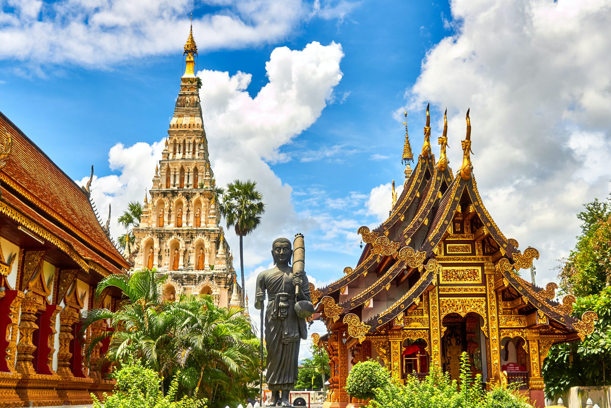 Image of ancient golden temples and a statue in Thailand